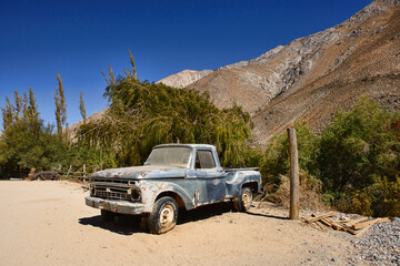 An old car parked in Cochiguaz village is noted for New Age and also UFO sightings. Note the falling object in the photo above the tree! Elqui Valley, Chile - Powered by Adobe