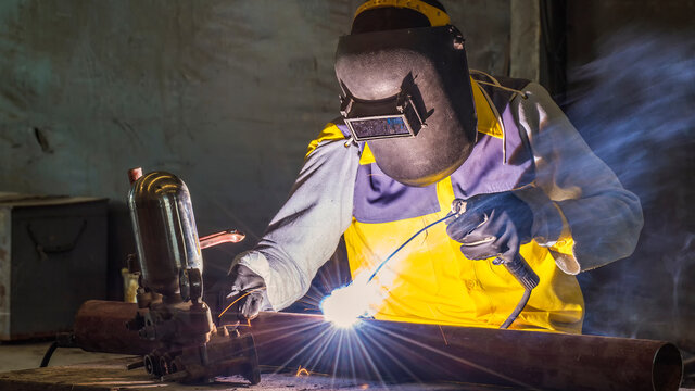 Banner photo of worker welding the steel part by manual. steel industrial, welding, repairing workshop and welding concept