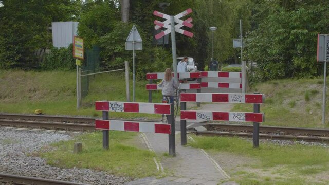 Two cyclists passing a unguarded level crossing in the Netherlands