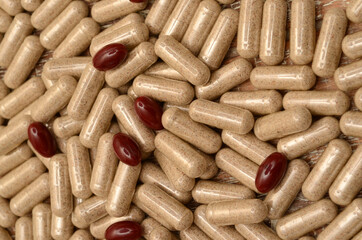 pills on a wooden background/lycopene/milk thistle/l-arginine