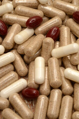 pills on a wooden background/milk thistle/lycopene/l-arginine