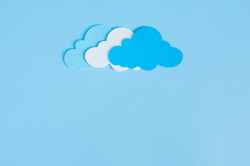 Light blue, white and blue paper cut clouds on blue background with copy space. 