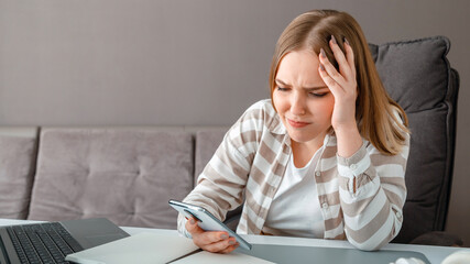 Young woman upset under stress. Confused woman holding head received bad news via smartphone at work. Teen girl looks at smartphone screen during negative emotions depression. Long web banner