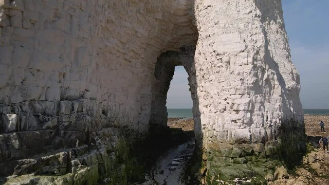 People exploring Kingsgate bay interesting chalk cliff coastal seashore aerial reverse view