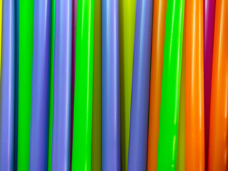 Obraz premium closeup colorful rainbow plastic straws abstract background, disposable straw for beverage