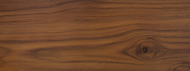 surface section of a teak wood plank or panel with wood grain, lumber board background texture for designing or banner