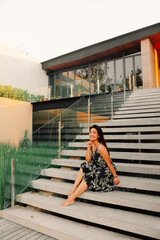 Asian woman sitting on ladder for relax in evening.
