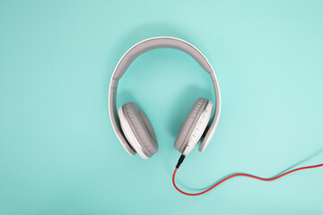 close up headphone on light blue background , relaxing with music concept 