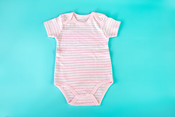pastel pink romper baby cloth on a light blue background