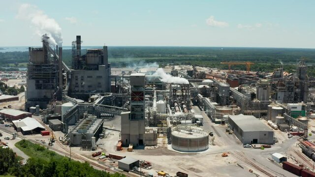 Pedestal shot of large manufacturing paper mill plant. Aerial view in summer.