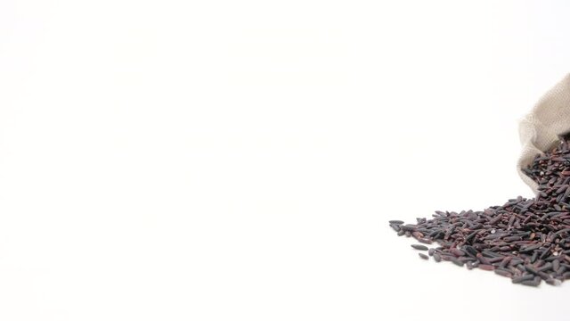 Dolly shot of Black rice berry in bag on white background,Close up.