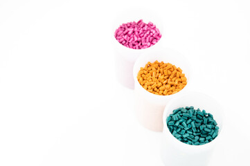 Obraz na płótnie Canvas Plastic granules close up for holding,Colorful Plastic granules with white background.