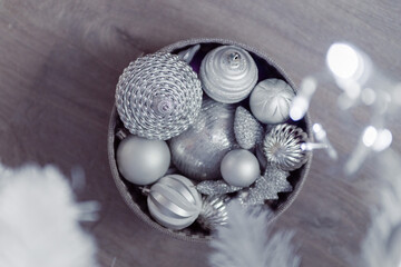 Christmas decoration balls in box on floor, grey silver color 