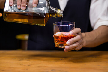 Bartender Serve Whiskey, on wood bar, 