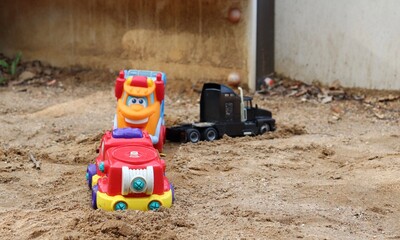 children's cars in the sandbox