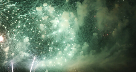 Naklejka na ściany i meble Green Firework celebrate anniversary happy new year 2022, 4th of july holiday festival. Green firework in night time celebrate national holiday. Countdown to new year 2022 festival party time event