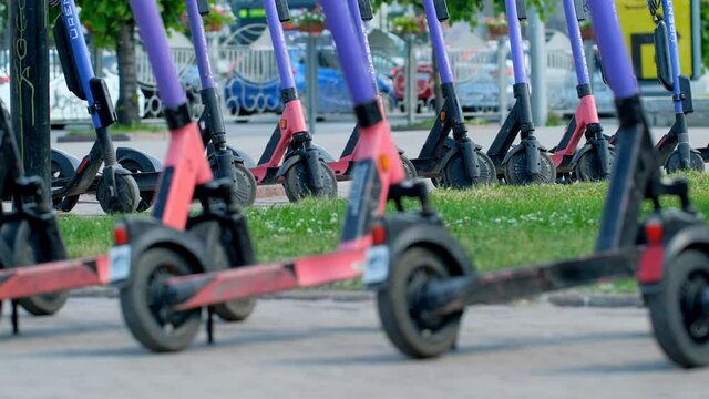 Scooter rental parking line. Eco vehicle 5g hotspot on e-board. Available electronic kick scooters urban passengers. Bicycle rent park with free wifi. Summer sharing for use a lot of people e-scooter.