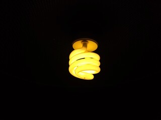 Lit light bulb in a dark background