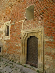 Fototapeta na wymiar old windows and doors on a brick wall, the atmosphere of the castle
