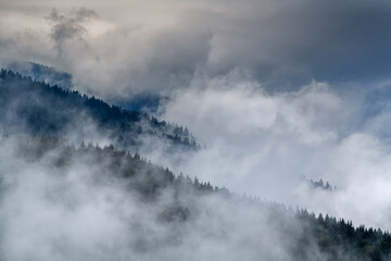 Majestic view on beautiful fog and cloud mountains in mist landscape