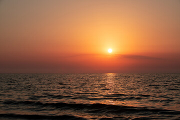 Fototapeta na wymiar The sun reflecting in the sea water after sunrise
