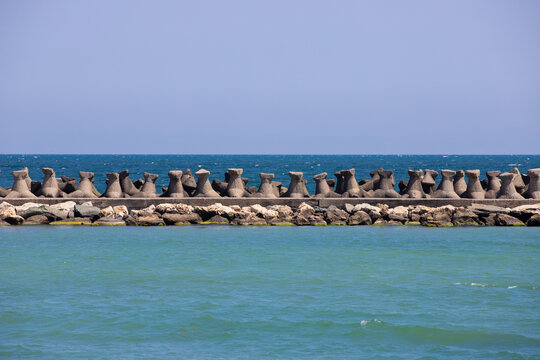 a dam of concrete stabilopos in the sea