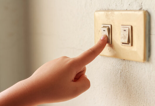 An Image Hand People Lowering The Power On Their Utilities Turn Off Light Switch Saving Energy Of The Home Interior.