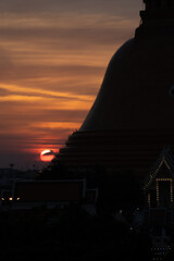 Obraz premium The Buddha house pagoda bigess of Thailand. Two man sitting and relax with sunset background