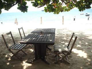Cafe on the beach. Wooden table on the sand 