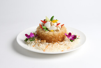 deep fried crispy taro yam ring with stir fried scallop and vegetables in white background asian halal menu