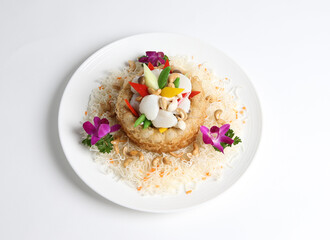 deep fried crispy taro yam ring with stir fried scallop and vegetables in white background asian halal menu