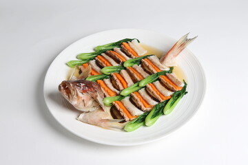steamed whole fish grouper seafood fillet in 2 way style and vegetable in white background asian halal menu