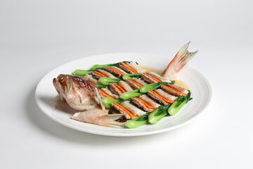 steamed whole fish grouper seafood fillet in 2 way style and vegetable in white background asian halal menu