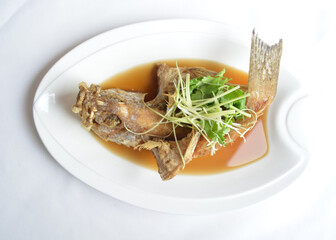 Hong Kong deep fried grouper fish seafood with soy sauce in white background asian halal menu