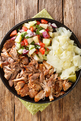 Kalua Pork the famous luau style pork made easy in the slow cooked served with stewed cabbage and fresh salad closeup in the slate plate on the table. Vertical top view from above - obrazy, fototapety, plakaty