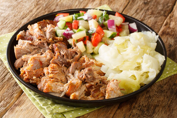 Hawaiian food Kalua pork slowly cooked and served with stewed cabbage and fresh pineapple salad...