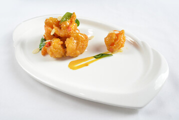 wok fried seafood prawn in pumpkin salted egg yolk sauce in white background asian halal menu