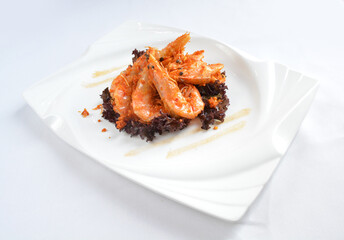 deep fried crispy big fresh tiger prawn in spicy chilli curry sauce in hot clay pot in white background asian halal menu