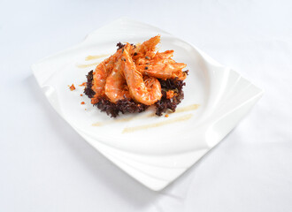 deep fried crispy big fresh tiger prawn in spicy chilli curry sauce in hot clay pot in white background asian halal menu