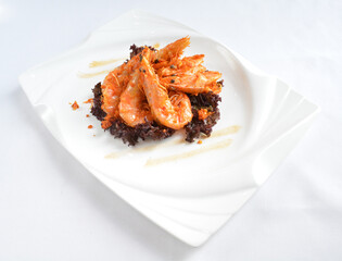deep fried crispy big fresh tiger prawn in spicy chilli curry sauce in hot clay pot in white background asian halal menu