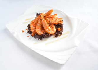 deep fried crispy big fresh tiger prawn in spicy chilli curry sauce in hot clay pot in white background asian halal menu