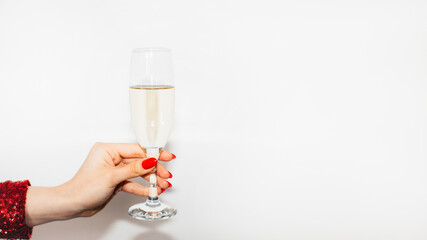 Christmas party. Festive drink. Happy celebration. Advertising background. Elegant female hand perfect red manicure holding champagne flute isolated white copy space.