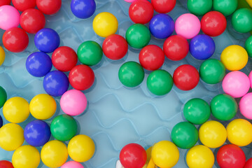 Color balls in swimming pool with water flat lay. High quality photo