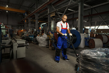 Fototapeta na wymiar Portrait of african american male handyman working in an industrial factory