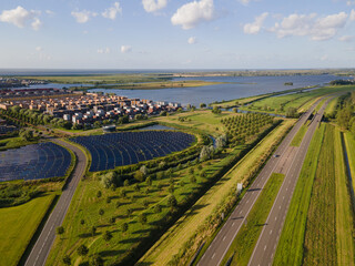 Modern innovative residential area in Almere, along the waterside, including solar panel field. The...
