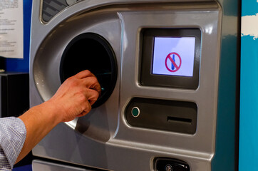 A reverse vending machine is a device that accepts used (empty) beverage containers and returns money to the user.