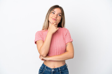 Young Romanian woman isolated on white background thinking an idea while looking up