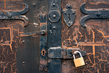 Old rusty metal door with padlock