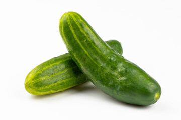 Two fresh cucumbers isolated on a white background.