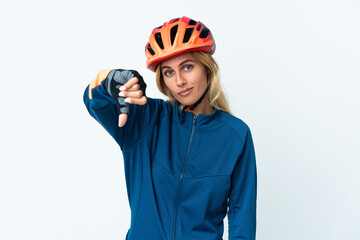 Young blonde Uruguayan cyclist woman isolated on background showing thumb down with negative expression